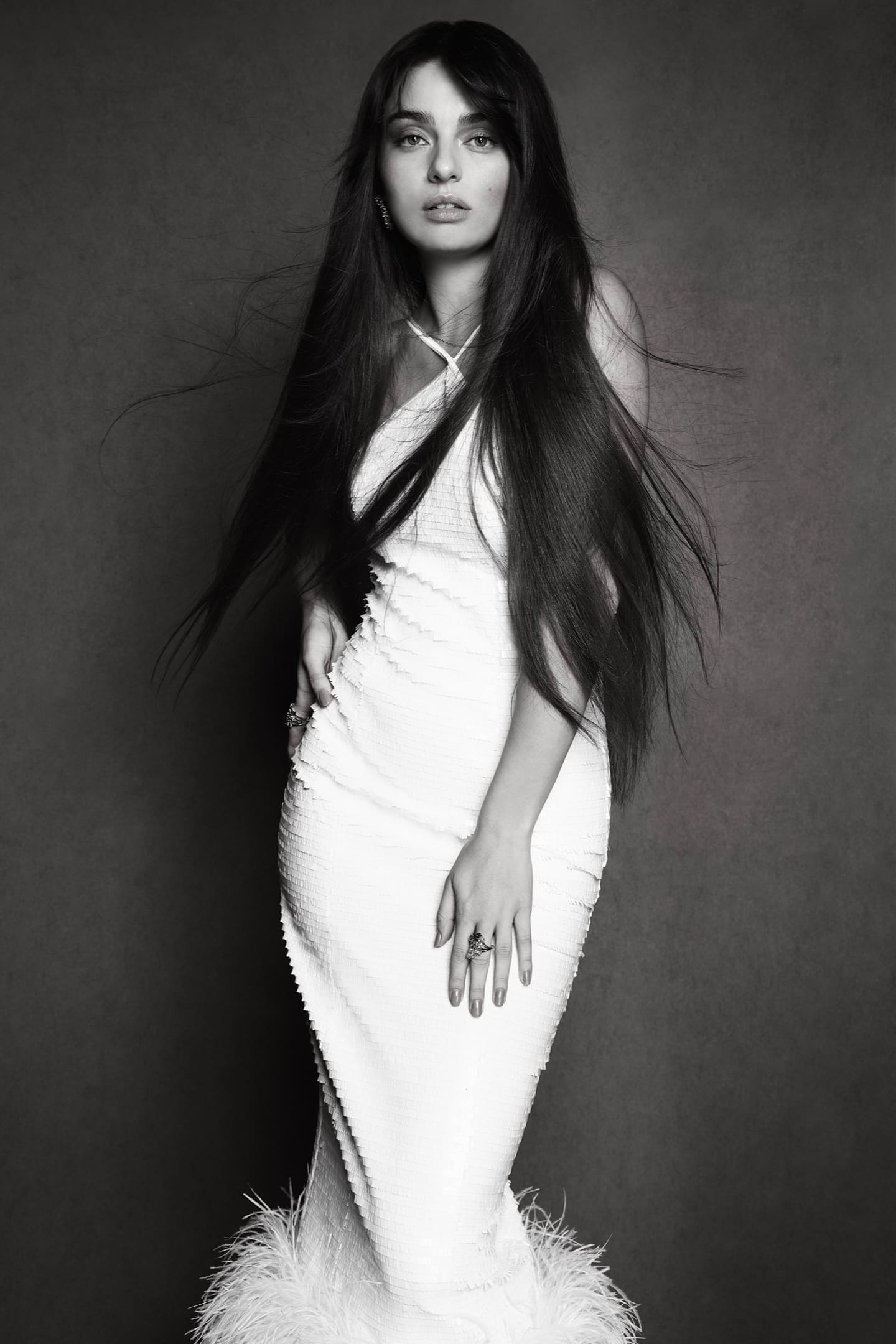 Ayça Ayşin Turan in a white fringed column gown with floor-length hair in a black-and-white studio portrait for Cover Story