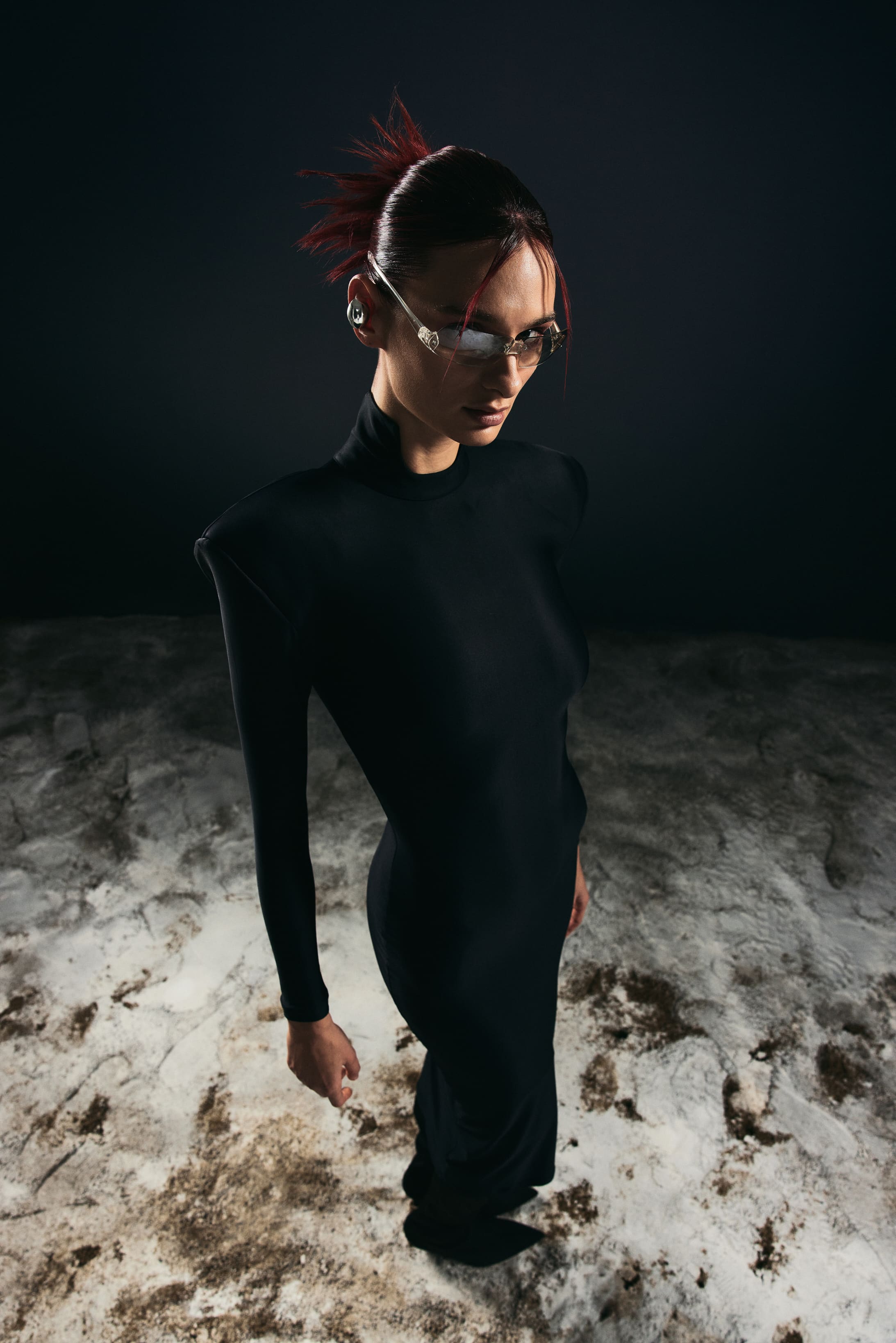 Shot from above, sculpted shoulders and rimless glasses cut through the dark in Mysamoon's night-world campaign.